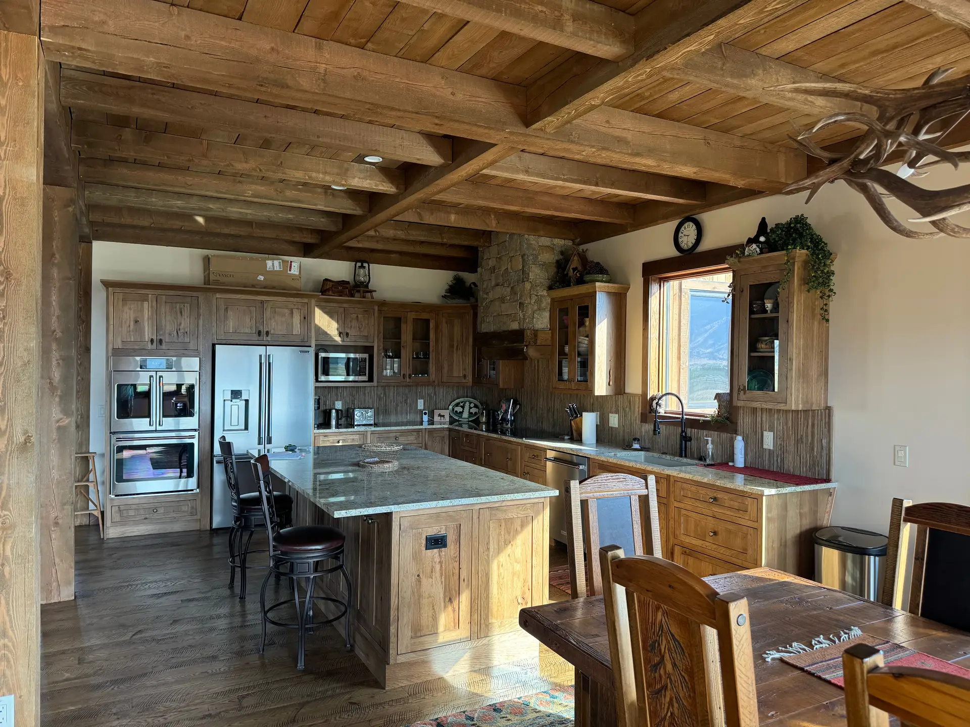 A finished kitchen under a heavy timber ceiling